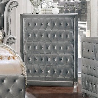 Alzir Grey Chest. Comforting cushioned velvet-like fabric encompasses this chic Alzir chest. It has a crystal like acrylic buttons and five storage drawers.