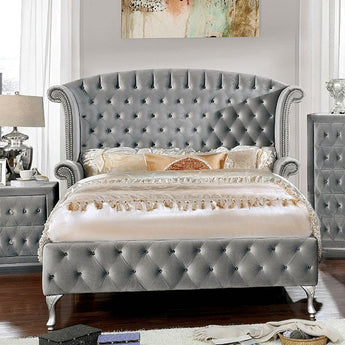 Alzir Buttontufted Bed in Grey. This chic Alzir button tufted bed comforts cushioned velvet-like fabric. It features a glamorous wingback headboard as glimmering acrylic button tufts and framing nailhead trim dazzles. Slat kit included.