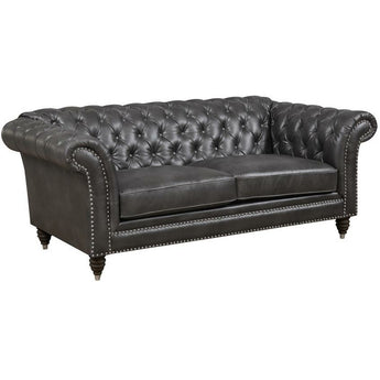Capone Dark Grey Loveseat. Features fully tufted back, nailhead trim, rolled arms and deep seating. Chesterfield-inspired design.