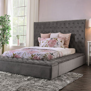 Davida Upholstered Bed in Grey. This bed is upholstered in a button-tufted flannelette from top to bottom, emphasizing the bold, chunky design. The footboard also acts as additional storage, pulling out on rails for ample organization space.
