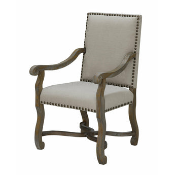 Crestview St. James Arm Chair. It features grey linen with nailheads surrounding the edges. Its curved legs and nailhead accents bring classic elegance to any room. The legs and armrests are in a medium-toned wood finish.