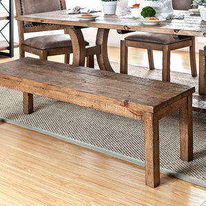 Gianna Wooden Bench in Rustic Oak. The weathered finish of the bench draws attention to the sturdy solid wood framework while providing the necessary support for a worry-free dinner setting. Plank design.