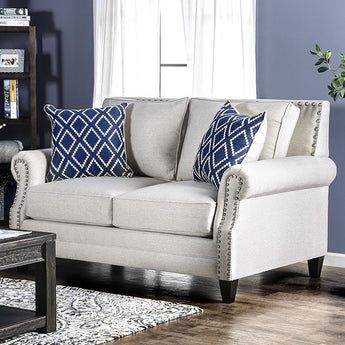 Giovanni Loveseat in Beige/Blue. Fitted back and seat cushions create a comforting seating environment while surrounded by shined nailhead trim. Rolled arms add emphasis to the timeless design while drawing attention to the tapered wood block legs below. Accent pillows included.