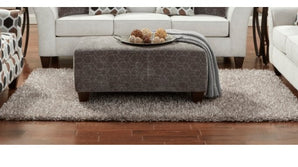 A sophisticated silver ottoman from Anna Collection featuring a chic design and comfortable seating.