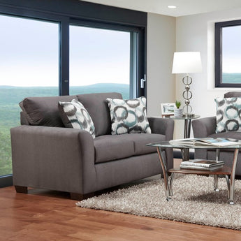 Relax and enjoy lasting comfort with Fleece Seal Loveseat! Cozy grey fabric and accent pillows create a luxurious feel.