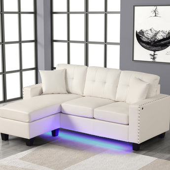 Messi white sectional with reversible chaise in durable faux leather. Features button tufted and nail head trim design.