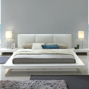 Christie California King Bed in White. The high gloss white finish brightens any setting while enhancing the bed’s padded headboard and low-profile design.