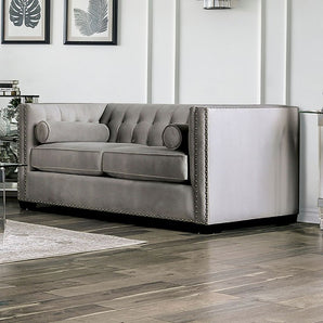 Elliot Loveseat in Light Gray. The Elliot Loveseat makes an elegant statement in any living room with its tuxedo style, welted box cushions, button tufting, and nailhead trim. Plush velvet upholstery, bolster pillows, and thick cushions provide all the comfort needed for entertaining.