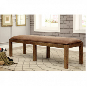 Gianna Rustic Dining Bench in Oak. The weathered finish of this bench draws attention to the sturdy solid wood framework while providing the necessary support for a worry-free dinner setting. The bench features an earthy-toned fabric that enhances the wood elements.