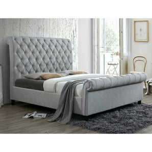 Kate Fully Upholstered Gray Bed. Beautifully designed and feature a scroll-shape with diamond tufting. 100% Polyester Fabric.