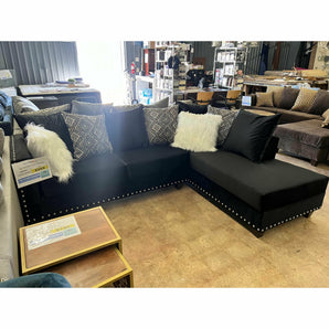 Black Upholstered Sofa and Chaise with nailhead trim.